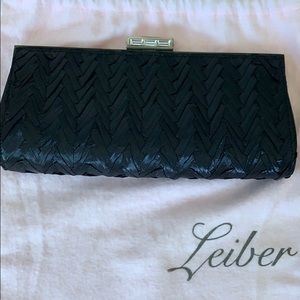 Judith Lieber black crossbody with gem closure